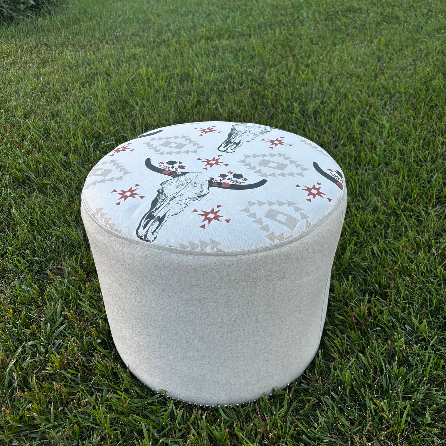 Angled outdoor view of ottoman showing full shape and print detail