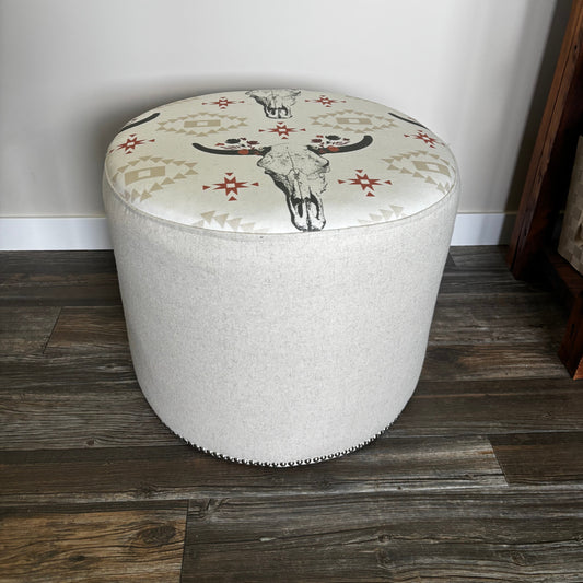 Angled view of cow skull ottoman showing top and side with decorative pattern
