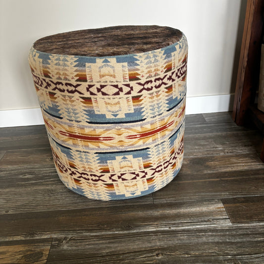 Side angle of ottoman displaying Pendleton Shonto Wheatlands fabric with geometric pattern in warm tones.
