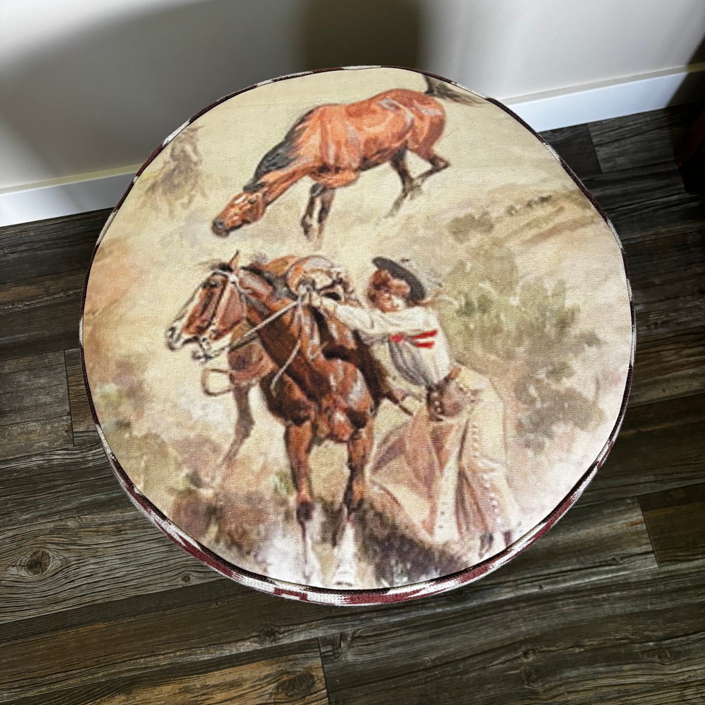 Top view of ottoman showing Charlie Russell Western horse and cowboy artwork