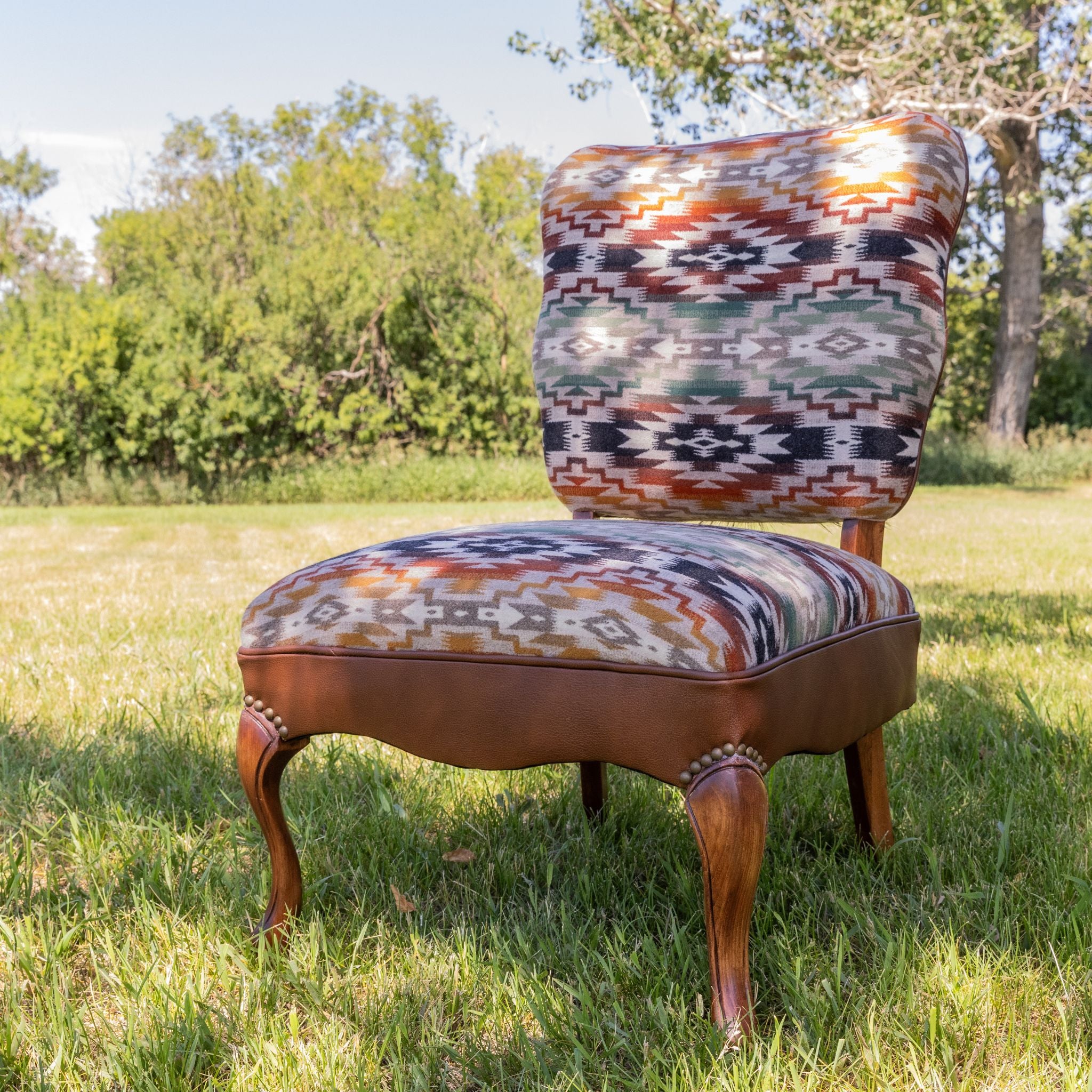 A past piece from blue dog fabric designs, aztec fabric and leather occasional chair