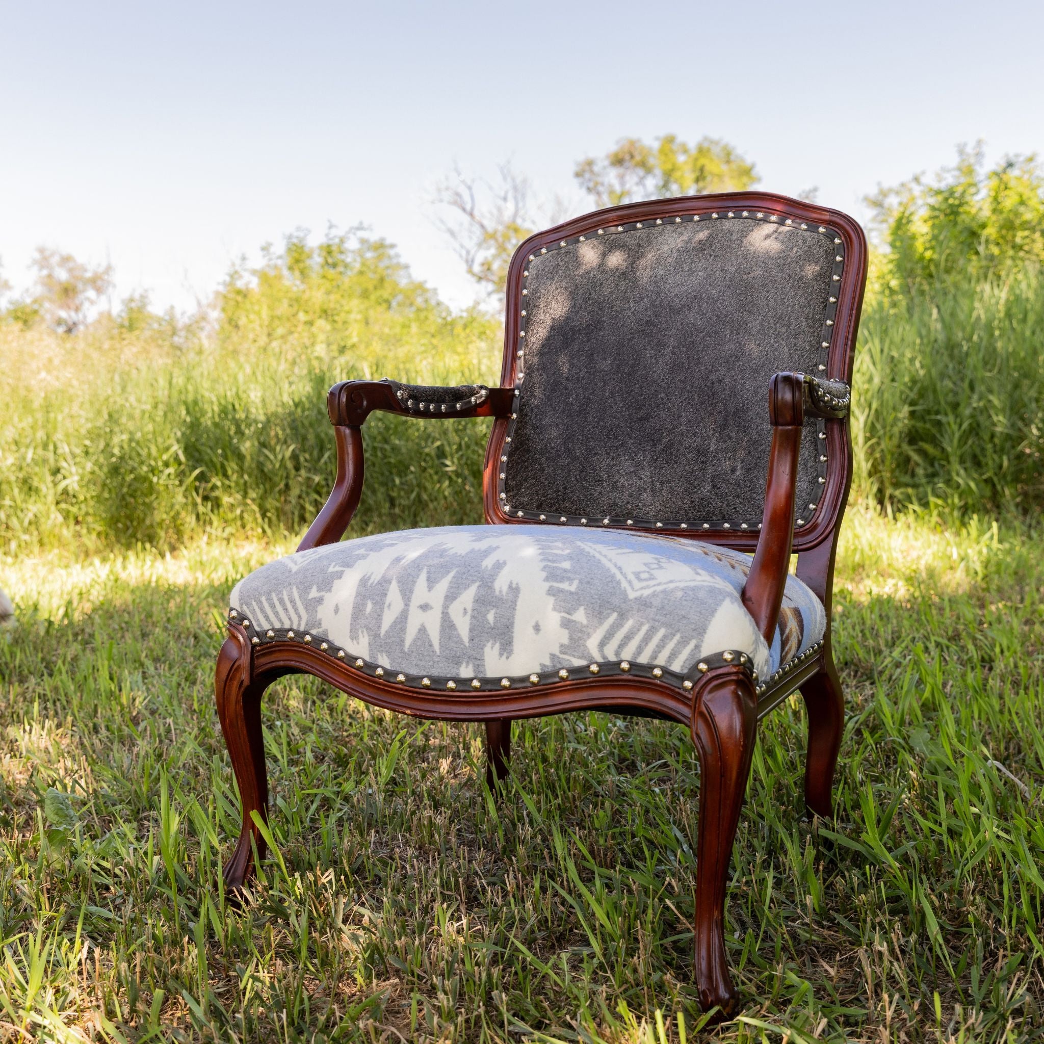 A past piece from blue dog fabric designs, restored occasional chair with aztec fabric and cowhide