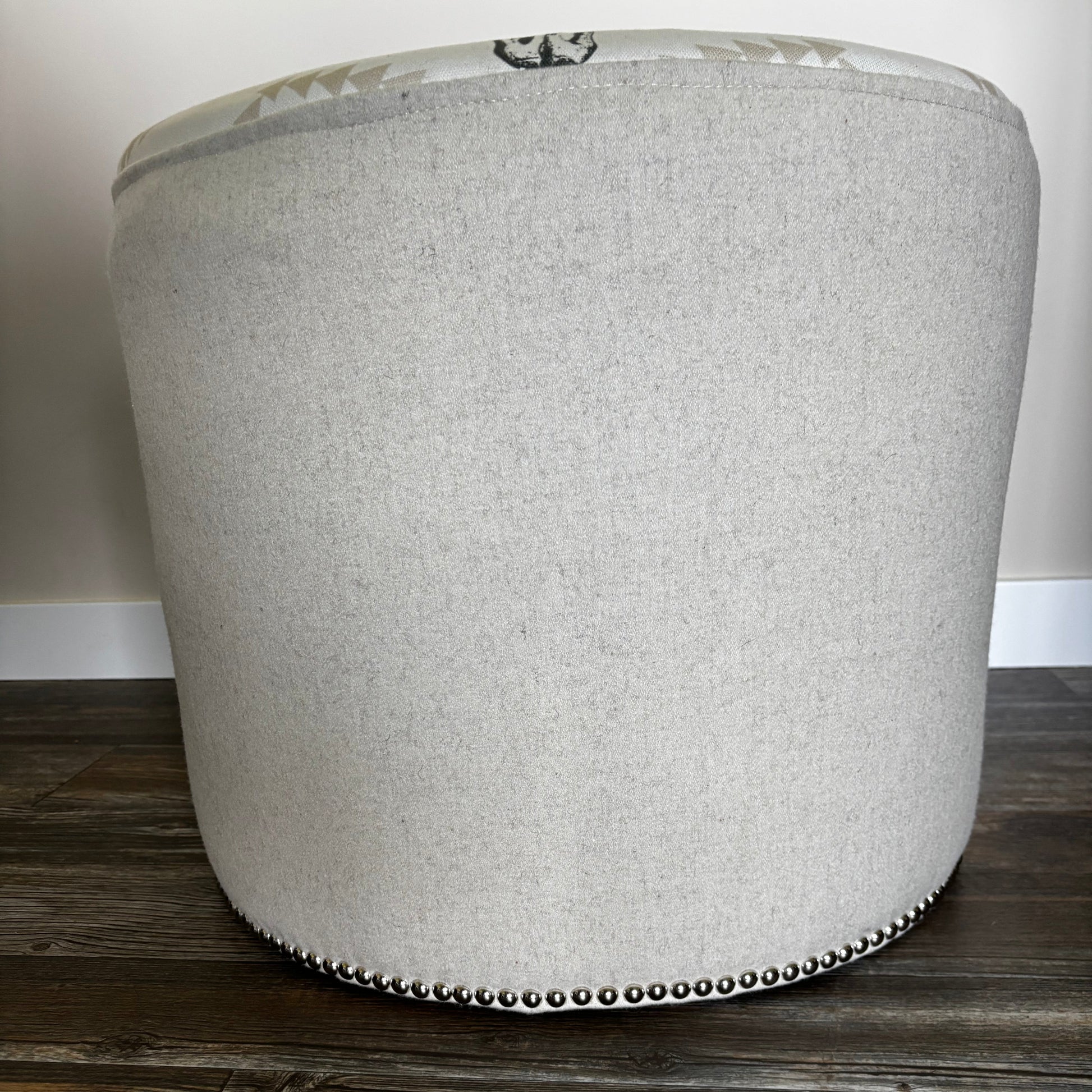 Close-up side view highlighting the white wool texture and nailhead trim