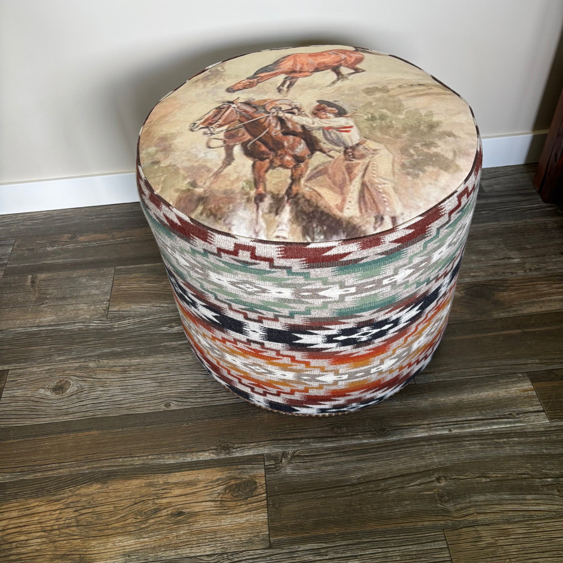 Handmade Alberta ottoman with Pendleton Mesilla fabric and Charlie Russell cowboy print (indoor photo, angled view)