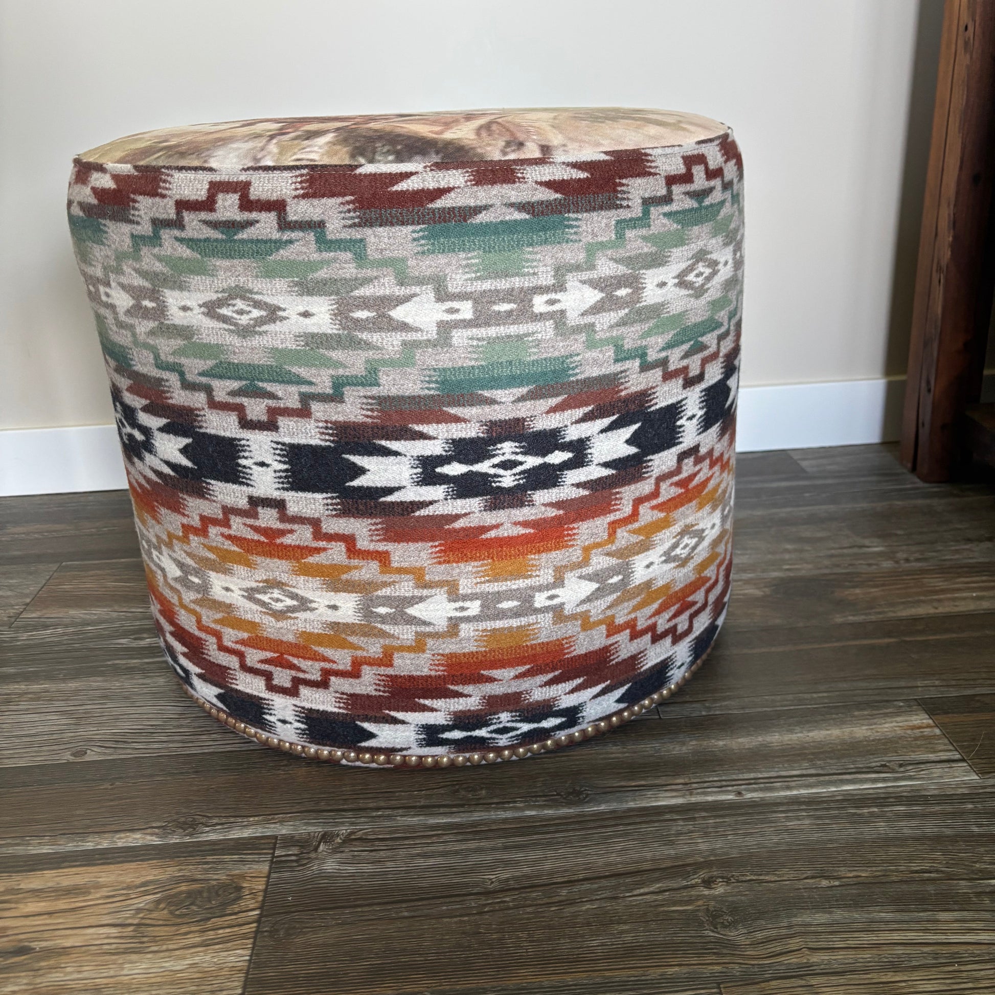 Side profile of ottoman with colorful Pendleton Mesilla pattern and nailhead trim