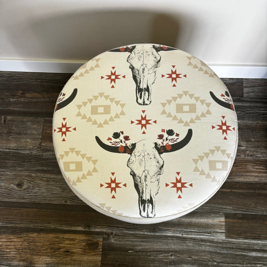 Top view of handmade ottoman featuring cow skull print on white wool fabric
