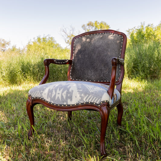 Vintage-style chair with Pendleton seat in a grassy outdoor setting
